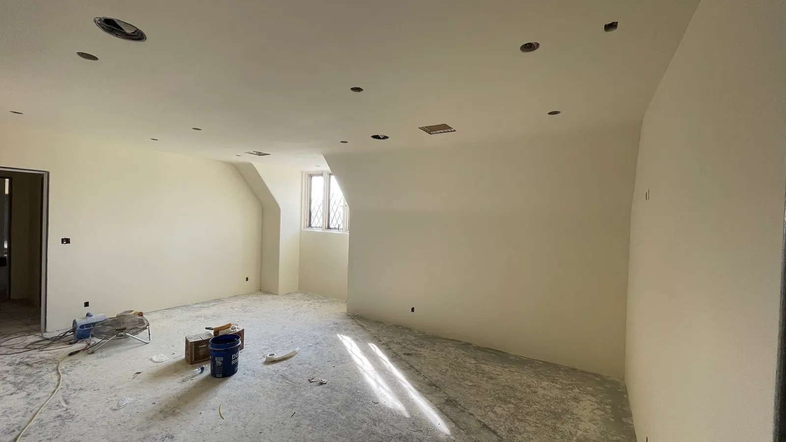 Skim-coated walls drying in a whole-house renovation